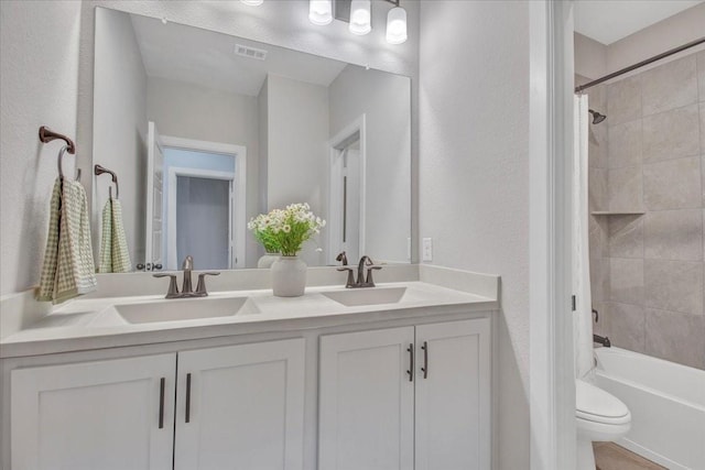 full bathroom with toilet, vanity, and shower / bath combo