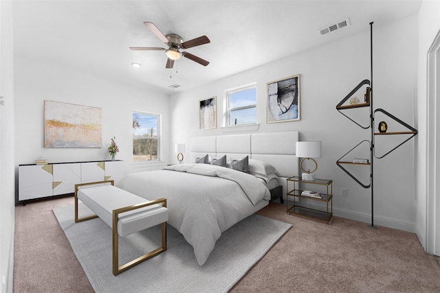 bedroom with ceiling fan and light colored carpet