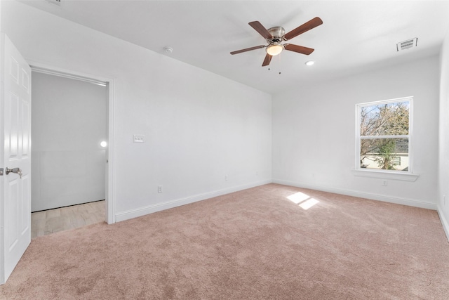 carpeted empty room featuring ceiling fan