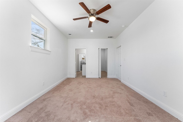 unfurnished bedroom featuring light carpet and ceiling fan