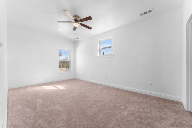 carpeted spare room with ceiling fan