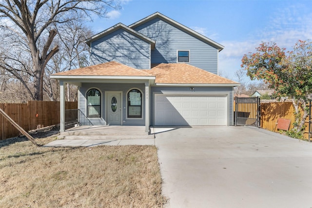 view of front property featuring a garage, a front yard, and covered porch