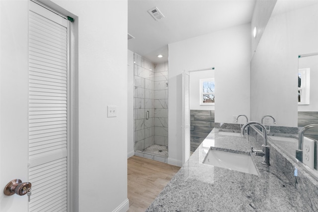 bathroom with vanity, hardwood / wood-style floors, and an enclosed shower