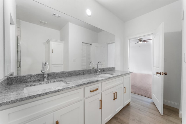 bathroom featuring ceiling fan, vanity, and hardwood / wood-style floors