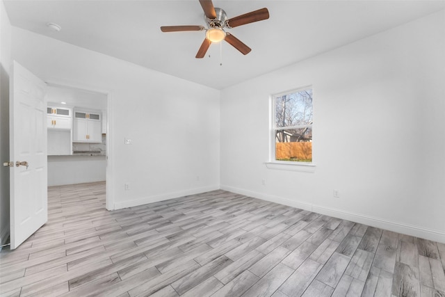 unfurnished room featuring ceiling fan and light hardwood / wood-style flooring