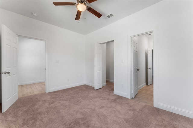 unfurnished bedroom with ceiling fan and light carpet