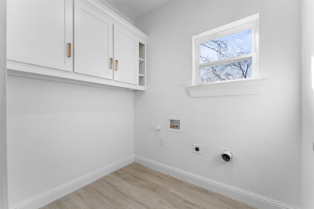 clothes washing area with gas dryer hookup, electric dryer hookup, hookup for a washing machine, cabinets, and light wood-type flooring