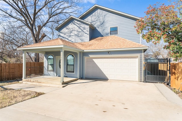 view of property with a garage and covered porch