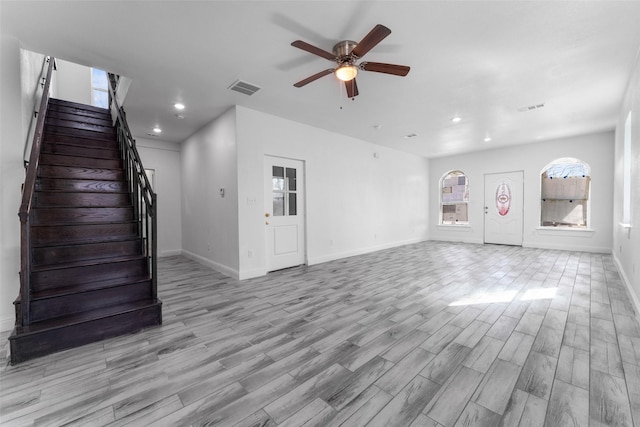 unfurnished living room featuring ceiling fan and light hardwood / wood-style flooring