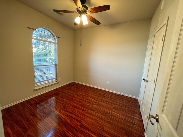 spare room with ceiling fan and dark hardwood / wood-style flooring