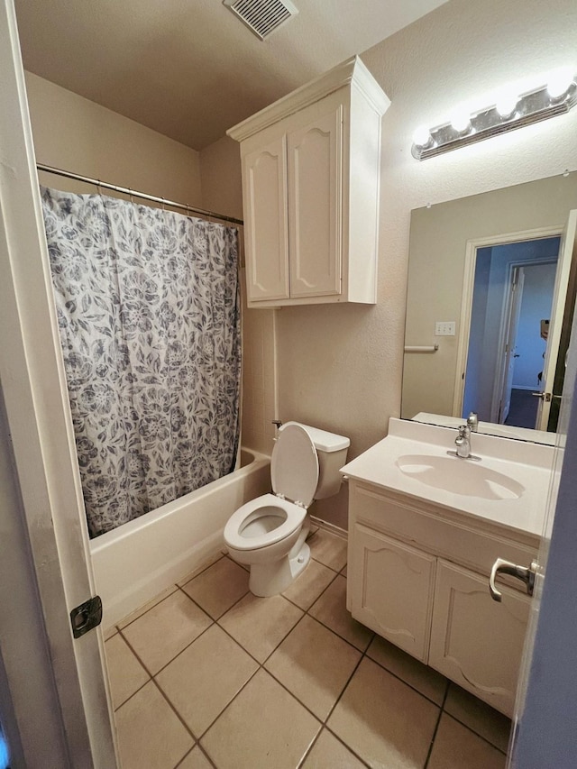 full bathroom featuring toilet, tile patterned flooring, shower / bath combo, and vanity