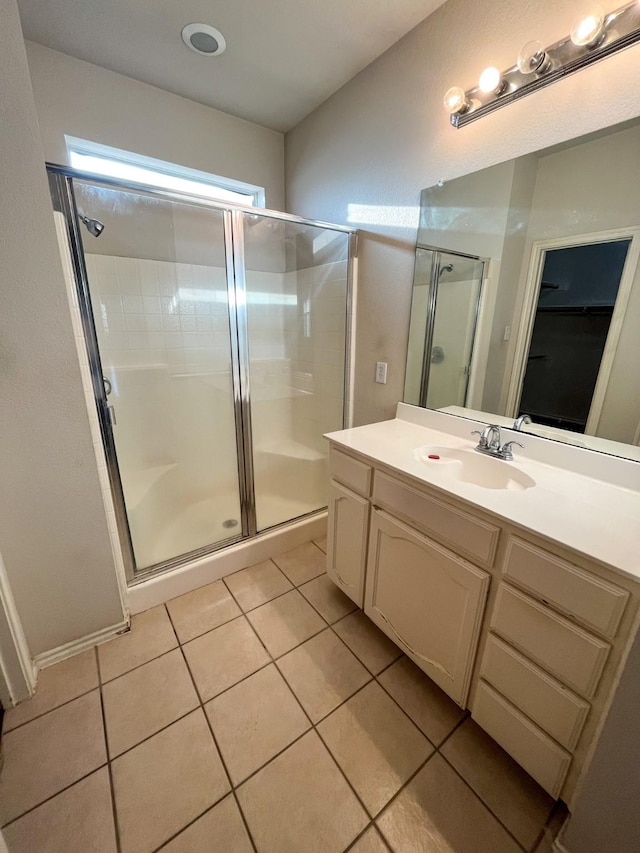 bathroom with vanity, tile patterned floors, and a shower with door