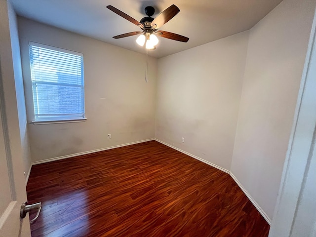 spare room with ceiling fan, dark hardwood / wood-style flooring, and a healthy amount of sunlight