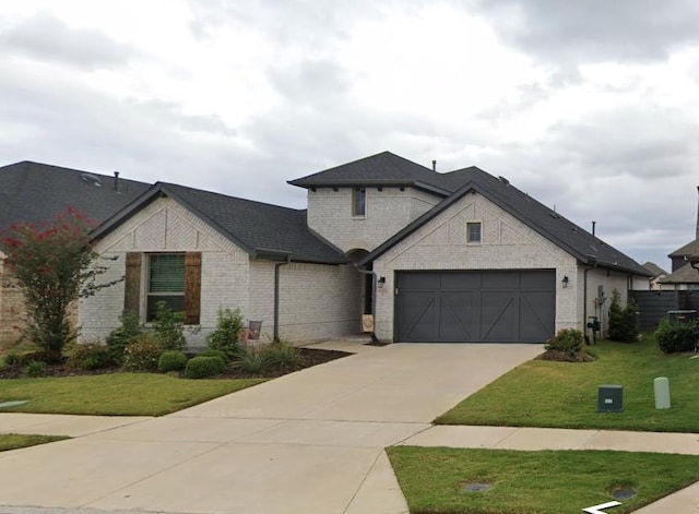 french country inspired facade with a front yard and a garage