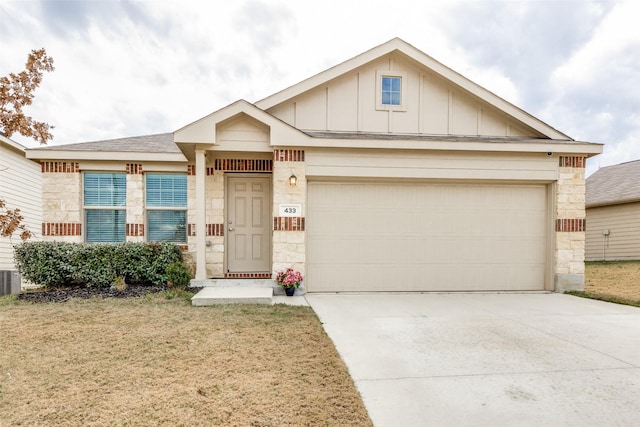 view of front of property featuring a garage and a front lawn