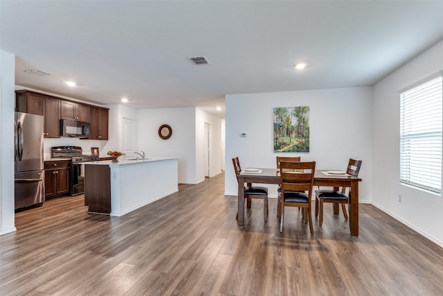 dining area featuring a wealth of natural light and dark hardwood / wood-style floors