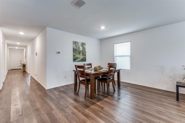 dining room with dark hardwood / wood-style flooring