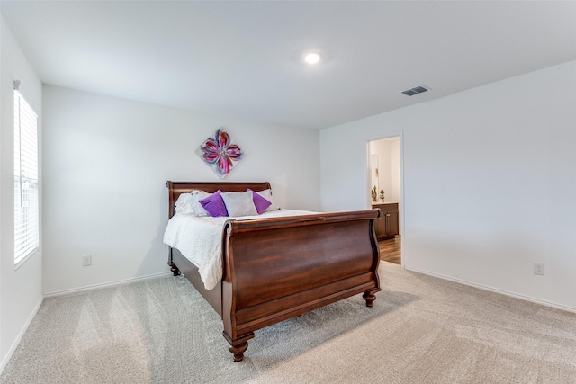 carpeted bedroom featuring connected bathroom