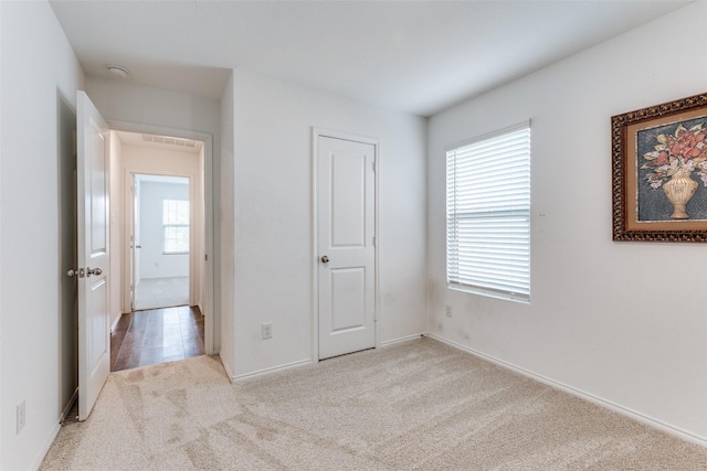 unfurnished bedroom featuring light colored carpet