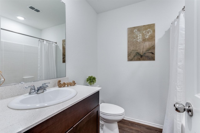 bathroom with toilet, vanity, wood-type flooring, and a shower with shower curtain