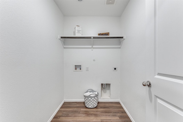 clothes washing area featuring washer hookup, dark hardwood / wood-style flooring, electric dryer hookup, and gas dryer hookup