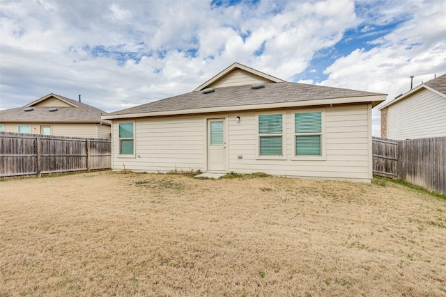 rear view of house with a lawn