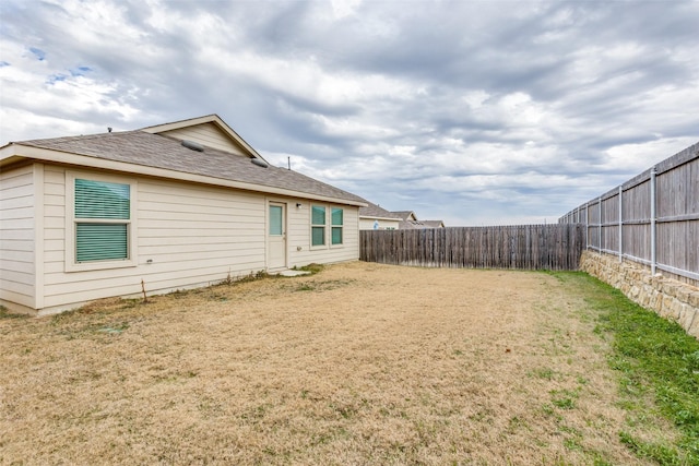 back of property featuring a lawn