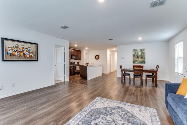 dining space featuring sink and dark hardwood / wood-style floors