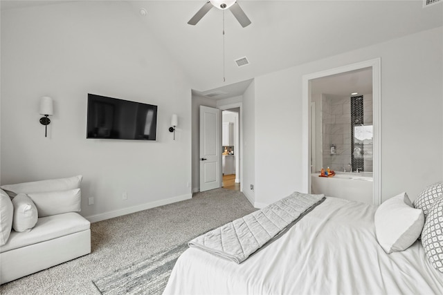 bedroom featuring vaulted ceiling, ceiling fan, ensuite bathroom, and light carpet