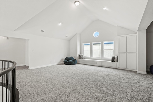 interior space featuring lofted ceiling and carpet flooring