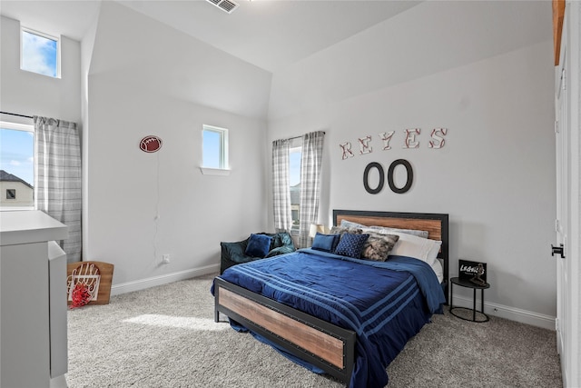 bedroom with light colored carpet and vaulted ceiling