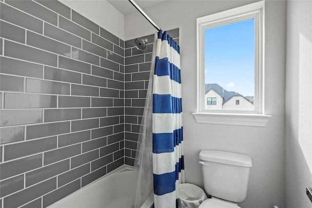 bathroom featuring toilet and shower / tub combo with curtain