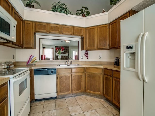 kitchen featuring ceiling fan, light tile patterned flooring, sink, and white appliances