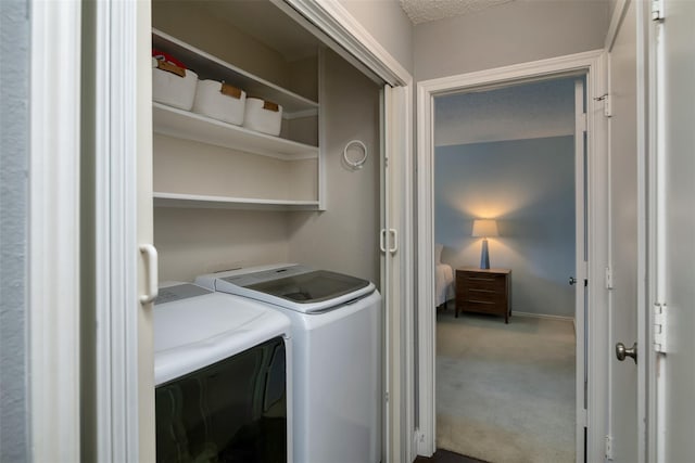 laundry room featuring washer and dryer and carpet flooring