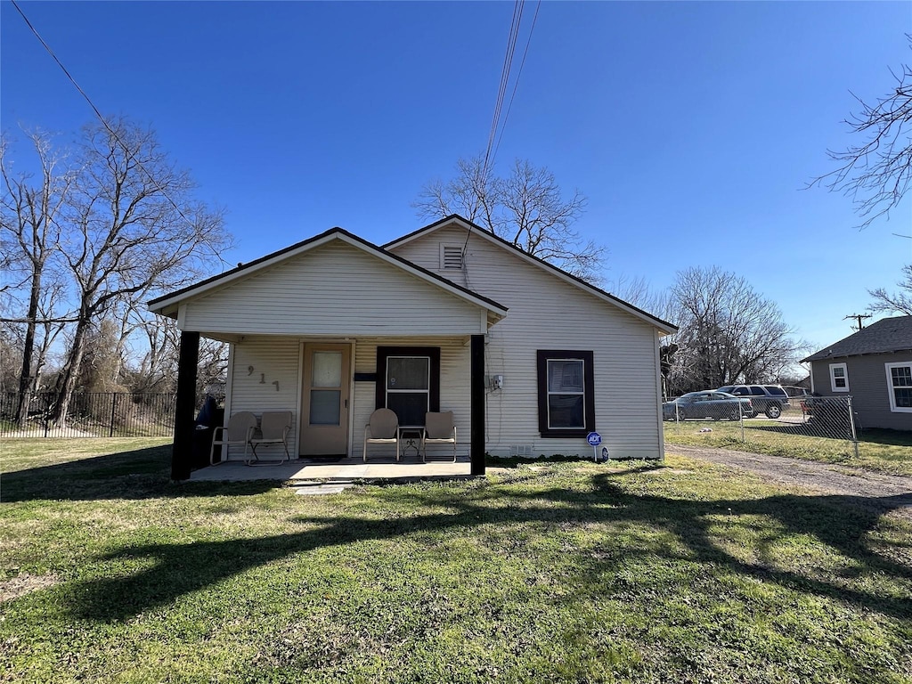 exterior space featuring covered porch and a front yard