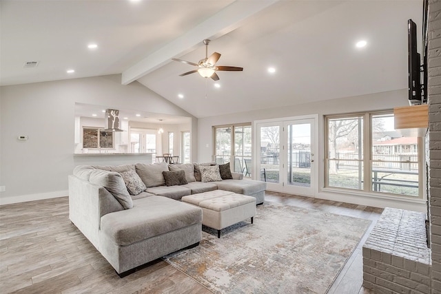 living room featuring ceiling fan, light hardwood / wood-style floors, high vaulted ceiling, and beamed ceiling