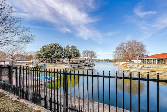 view of swimming pool with a boat dock and a water view