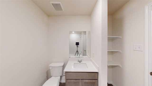 bathroom featuring toilet and vanity