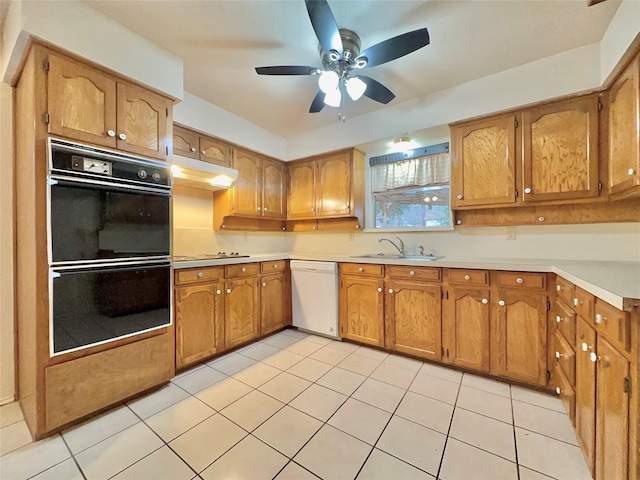 kitchen featuring ceiling fan, double wall oven, sink, white dishwasher, and light tile patterned floors