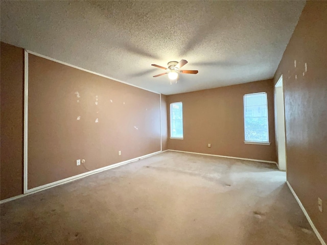 carpeted spare room with ceiling fan and a textured ceiling