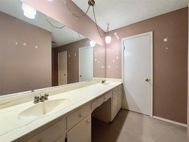 bathroom with a textured ceiling and vanity