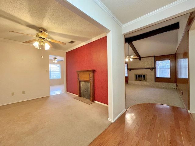 unfurnished living room with light carpet, a brick fireplace, crown molding, and a textured ceiling