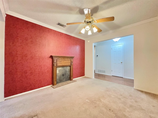 unfurnished living room featuring ceiling fan, crown molding, a textured ceiling, and carpet flooring