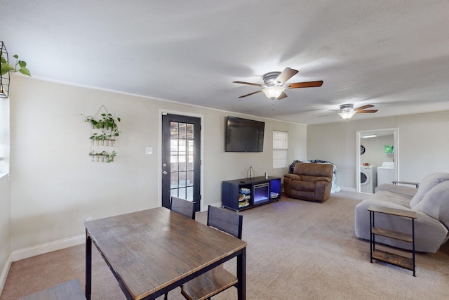 carpeted dining room featuring washing machine and clothes dryer