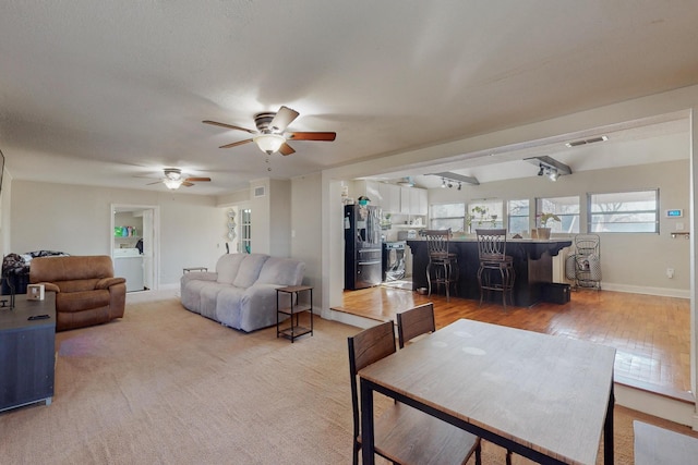 living room featuring wood-type flooring and ceiling fan