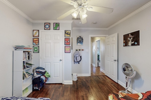 interior space with ornamental molding, dark wood-type flooring, and ceiling fan