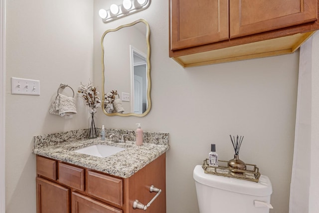 bathroom with toilet and vanity