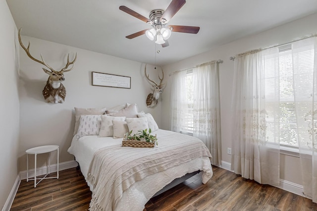 bedroom with ceiling fan and dark hardwood / wood-style floors