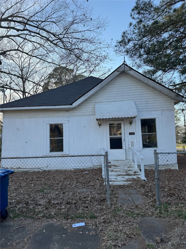 bungalow-style home with fence