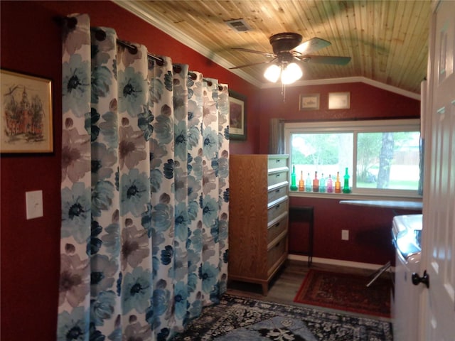 interior space featuring vaulted ceiling, ceiling fan, ornamental molding, and wood ceiling